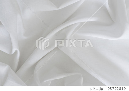 White drapery linen fabric background. Texture of the light surface of the fabric. White drapery linen fabric background. Texture of the light surface of the fabric. 93792819