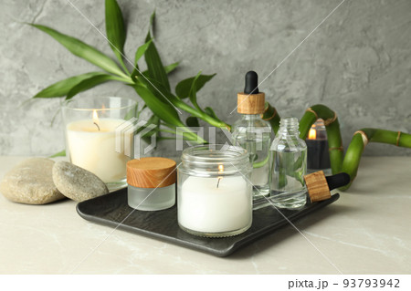 Concept of relaxation with aroma candles on light textured table 93793942