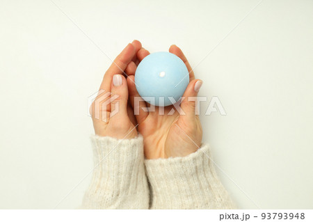 Female hands hold aroma candle on white background Female hands hold aroma candle on white background 93793948