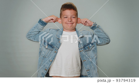 Funny toddler boy making playful silly facial expressions, grimacing, fooling around showing tongue Funny toddler boy making playful silly facial expressions, grimacing, fooling around showing tongue 93794319