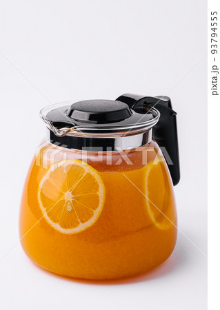 Orange tea in a jug with orange pieces 93794555