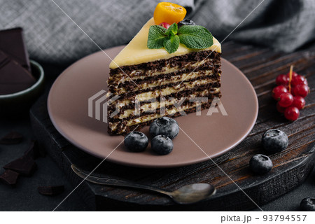 chocolate vanilla cake with berries on plate 93794557