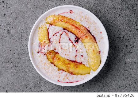 Oatmeal with fried banana on stone 93795426