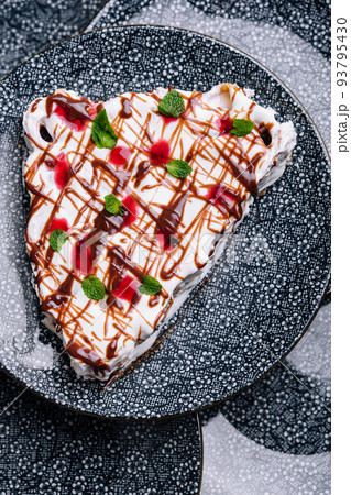 cake with cherry jam on ceramic plate 93795430