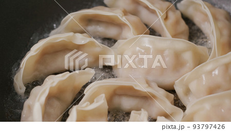 Grilling japanese dumpling on fry pan 93797426