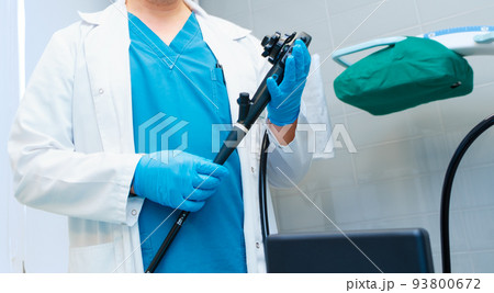 Selective focus on doctor's hands holding an endoscope. Selective focus on doctor's hands holding an endoscope. 93800672