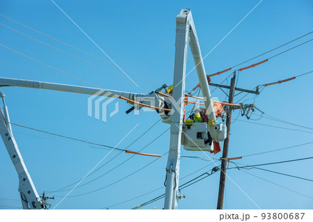 It is a job for the electrician worker to repair the damaged power lines caused by the storm in the electric power pole maintenance industry. 93800687