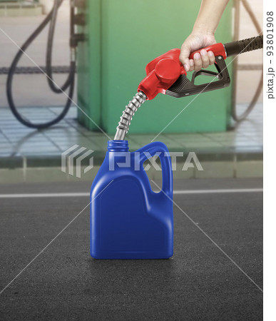 A man fills jerry cans at a gas station A man fills jerry cans at a gas station 93801908