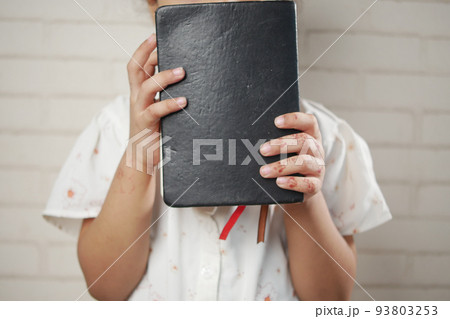 child girl holding many colorful notepad sited on chair child girl holding many colorful notepad sited on chair 93803253