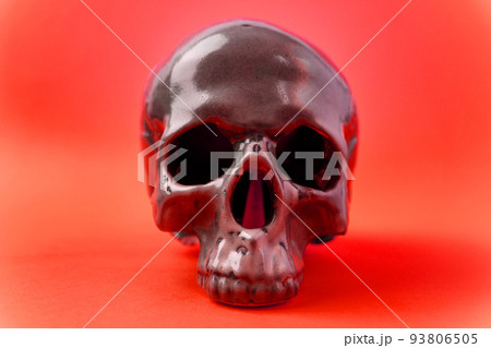 Human skull, creative arrangement against red background. Halloween inspiration. Human skull, creative arrangement against red background. Halloween inspiration. 93806505