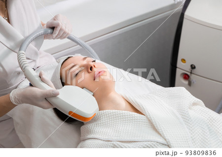 Skin lifting Procedure in a cosmetology clinic. The procedure of hardware liposuction of the neck and chin. Removal of the second chin in a woman. 93809836