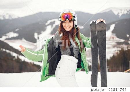 Woman skier in a winter day at a ski resort Woman skier in a winter day at a ski resort 93814745