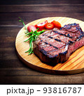 grilled ribeye steak on wooden board 93816787