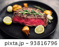 delicious steak on black plate served with rosemary 93816796