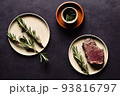 delicious steak and rosemary branch on white plate 93816797