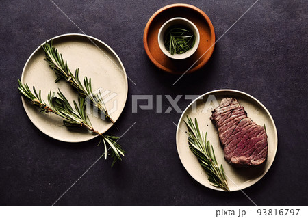 delicious steak and rosemary branch on white plate 93816797