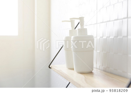 Alcohol sanitizers or alcohol gel from pump bottle on a shelf in bathroom. Hygiene and health care concept Alcohol sanitizers or alcohol gel from pump bottle on a shelf in bathroom. Hygiene and health care concept 93818209