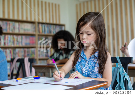 Girl is doing homework in the Classroom. Back to school! 93818504