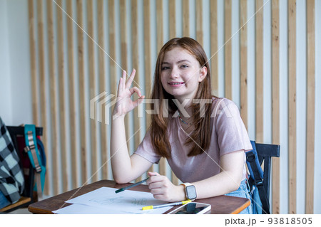Girl is doing homework in the Classroom. Back to school! 93818505