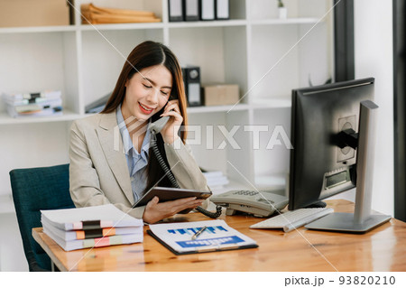 Happy asian business woman have the joy of talking on the smartphone, tablet and laptopon the modern office . 93820210