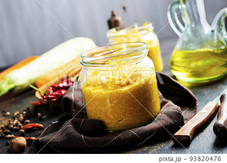 Delicious squash caviar in a jar on the table. Homemade caviar with zucchini, garlic, carrots, tomato sauce. Vegan cuisine. 93820476