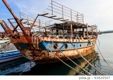 Old rusty and abandoned ship in a port in Nessebar, Bulgaria Old rusty and abandoned ship in a port in Nessebar, Bulgaria 93820507