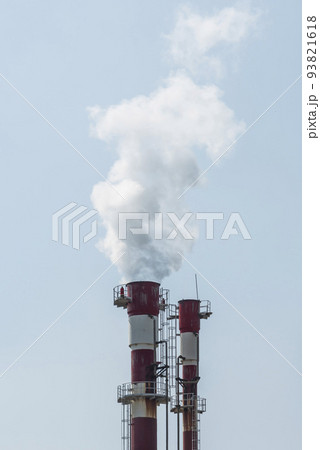 Air pollution by smoke coming out of two factory chimneys. 93821618