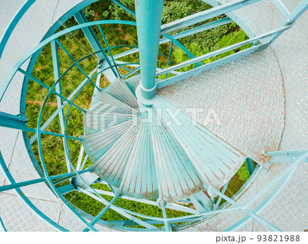 Metal spiral staircase leading the lookout tower. Perforated stairs 93821988