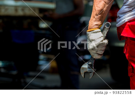Wrench in Hand of car mechanic. Hand holding a metal Wrench	 93822558