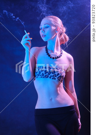 woman blowing smoke 93823720