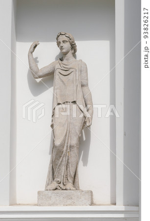 old sculpture of woman goddess in front of classic style house. Female statue in a european garden old sculpture of woman goddess in front of classic style house. Female statue in a european garden 93826217