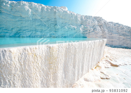 Blue outdoor pool in white rock. Natural travertine pools and terraces in Pamukkale. Cotton castle in southwestern Turkey. Vacation in beautiful nature. Sustainable Blue outdoor pool in white rock. Natural travertine pools and terraces in Pamukkale. Cotton castle in southwestern Turkey. Vacation in beautiful nature. Sustainable 93831092
