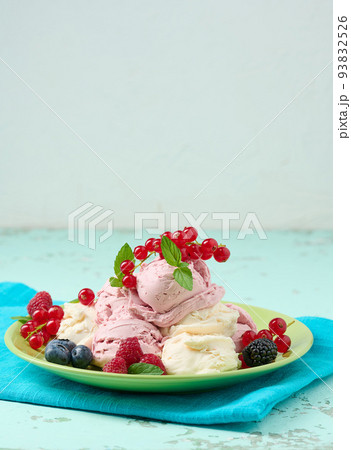 Vanilla ice cream balls with red raspberries in a round plate. Vanilla ice cream balls with red raspberries in a round plate. 93832526