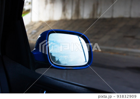 Car side mirror on the background of the autumn road Car side mirror on the background of the autumn road 93832909