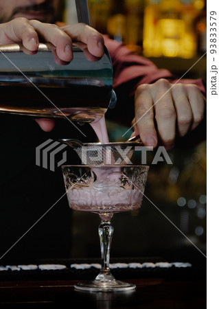 preparation by a barman of a cocktail 93833579