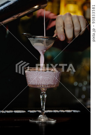 preparation by a barman of a cocktail 93833581