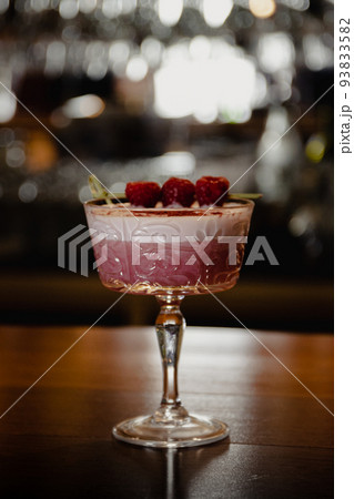 pink cocktail with a layer of white foam 93833582