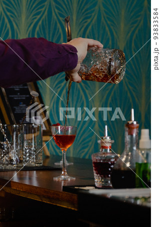 preparation by a barman of a cocktail 93833584