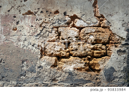 Brick wall wall with fallen off plaster 93833984