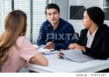 Young female asian candidate tries to impress interviewer by being competent. Young female asian candidate tries to impress interviewer by being competent. 93835187