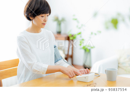 リビングのミドル女性　血圧計 93837554