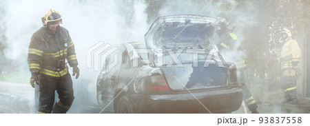 The fire brigade extinguishes a burning car. Arson of a car in the city. The fire brigade extinguishes a burning car. Arson of a car in the city. 93837558