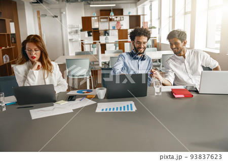 Busy coworkers cooperating and working together at office meeting, teamwork concept 93837623