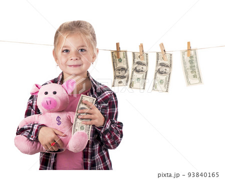 children and money. Girl with a piggy bank. Girl hanging dollar bills on a rope isolated on white background 93840165