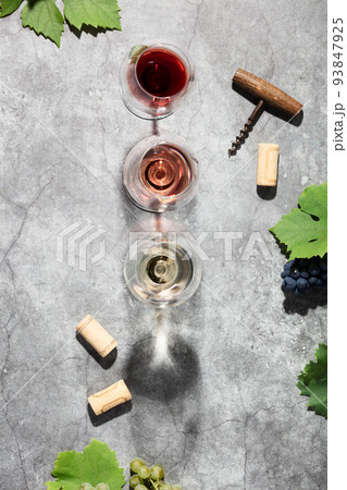 Wine composition with beautiful sunlight and shadows on grey background. Top view, flat lay 93847925
