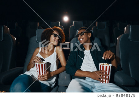Young people in the cinema. 93848179