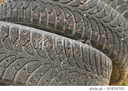Tires with rusty spikes. Close-up view. Shallow depth of field. 93850782