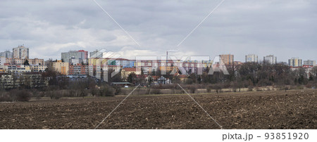 Chodov, Prague, Czech Republic, March 13, 2021: Panoramic view of Housing Estate Chodov with prefabricated buildings or block of flats constructed with panels over the bare field. Cloudy spring day 93851920