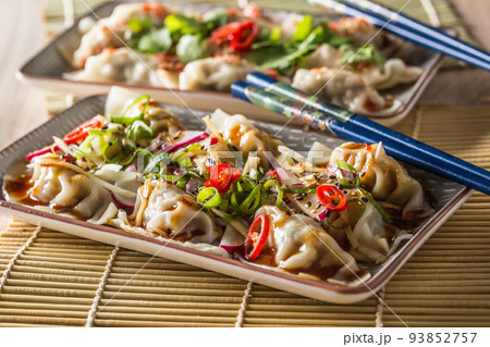 Japanese dumplings Gyoza stuffed chicken meat or vegetable with chili and herbs Japanese dumplings Gyoza stuffed chicken meat or vegetable with chili and herbs 93852757