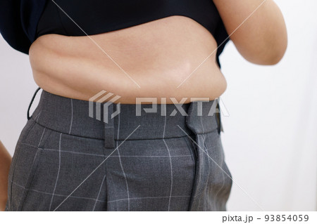 Women body fat belly. Obese woman hand holding excessive belly fat. diet lifestyle concept to reduce belly and shape up healthy stomach muscle. Women body fat belly. Obese woman hand holding excessive belly fat. diet lifestyle concept to reduce belly and shape up healthy stomach muscle. 93854059
